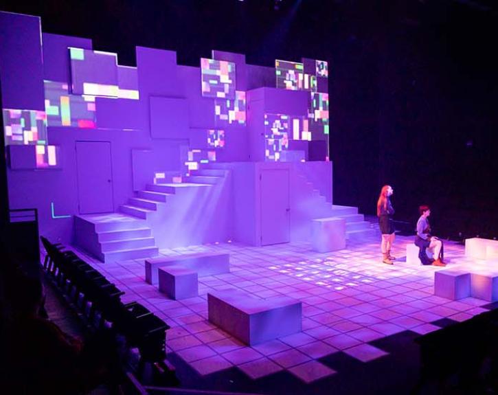 Love and Information at UT Austin; stage in a grid lit in purple light