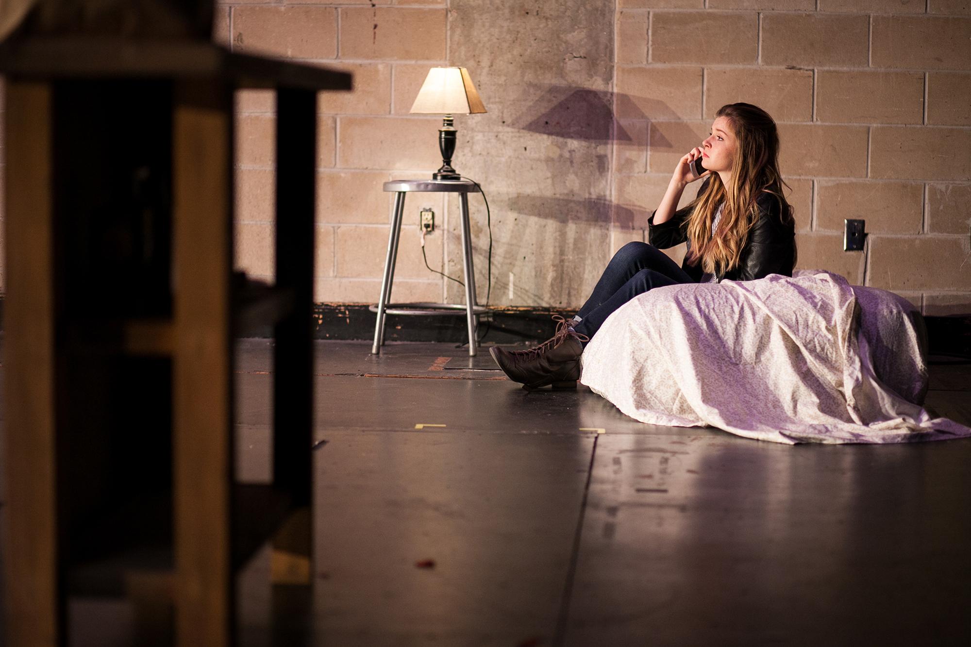 woman sitting on a mattress on the floor