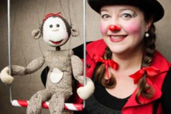 Honey Goodenough in clown make up with a sock puppet 