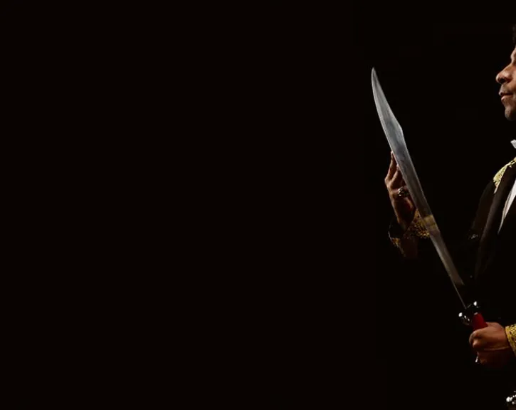 Merchant of Venice at UT Austin; Man admiring blade