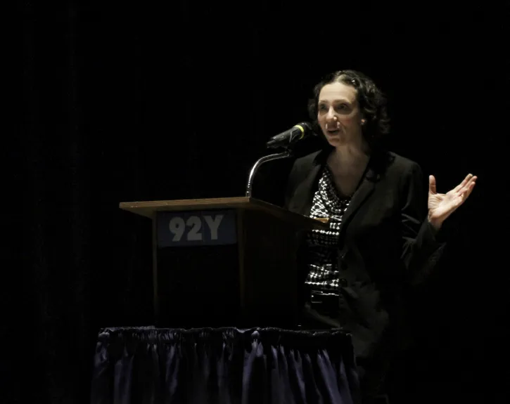 Rebecca Rossen at podium discussing NEH grant