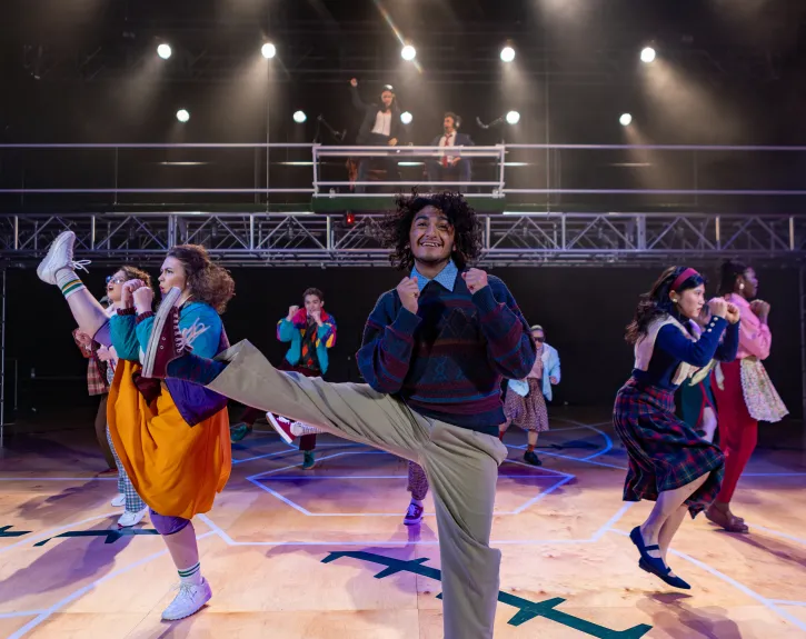 An ensemble of actors perform an upbeat jazzercise routine in A BEAUTIFUL DAY IN NOVEMBER ON THE BANKS OF THE GREATEST OF THE GREAT LAKES