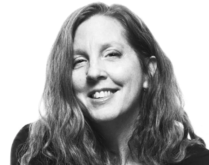A black and white headshot of a woman smiling