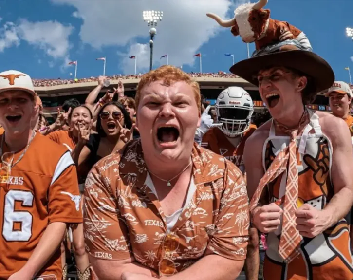 Acting major Preston Powe cheers enthusiastically at a Texas Longhorns football game