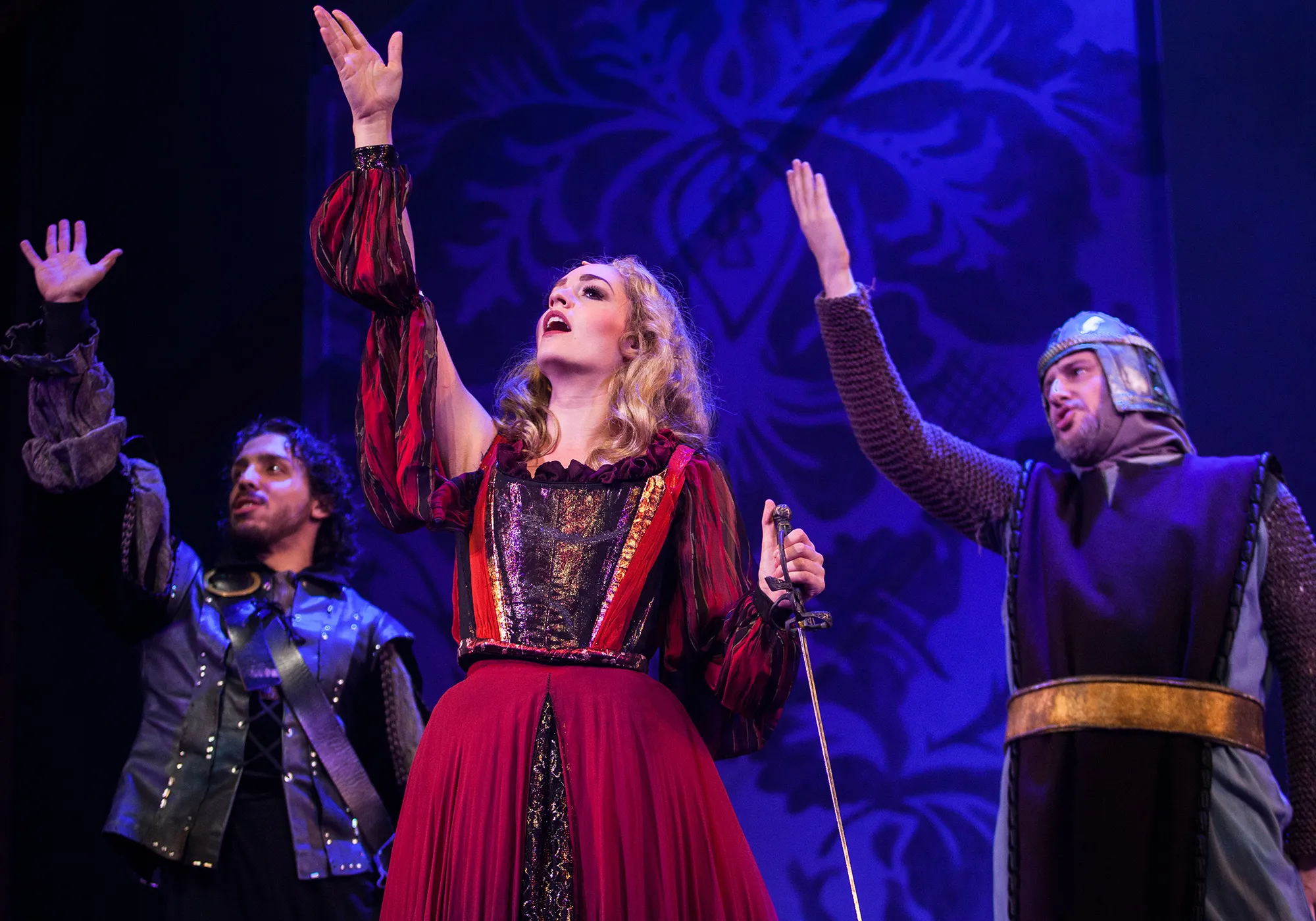 woman with two men raising their hands