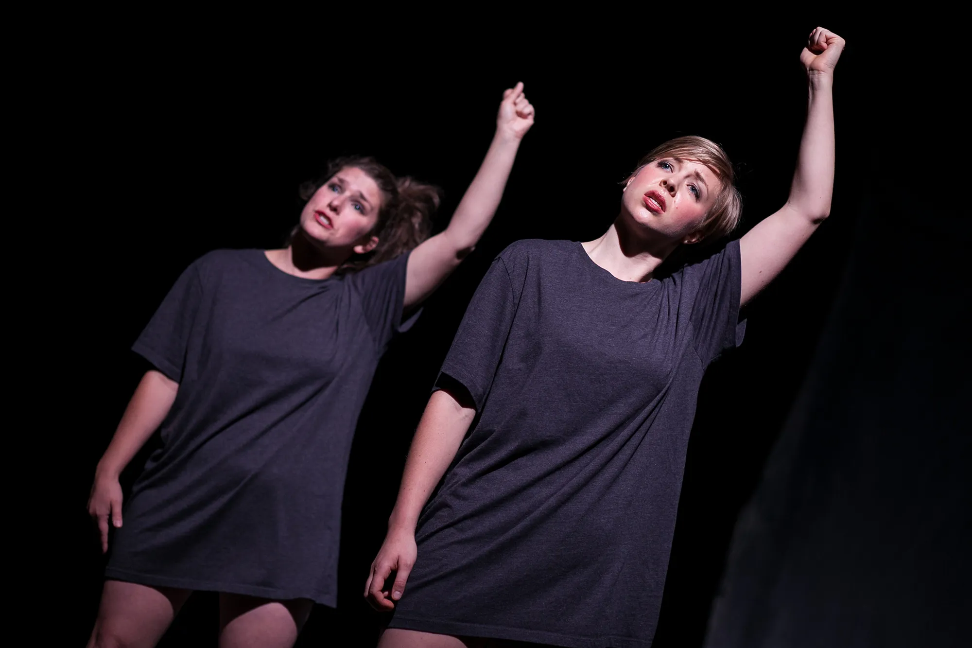 two women with arms up