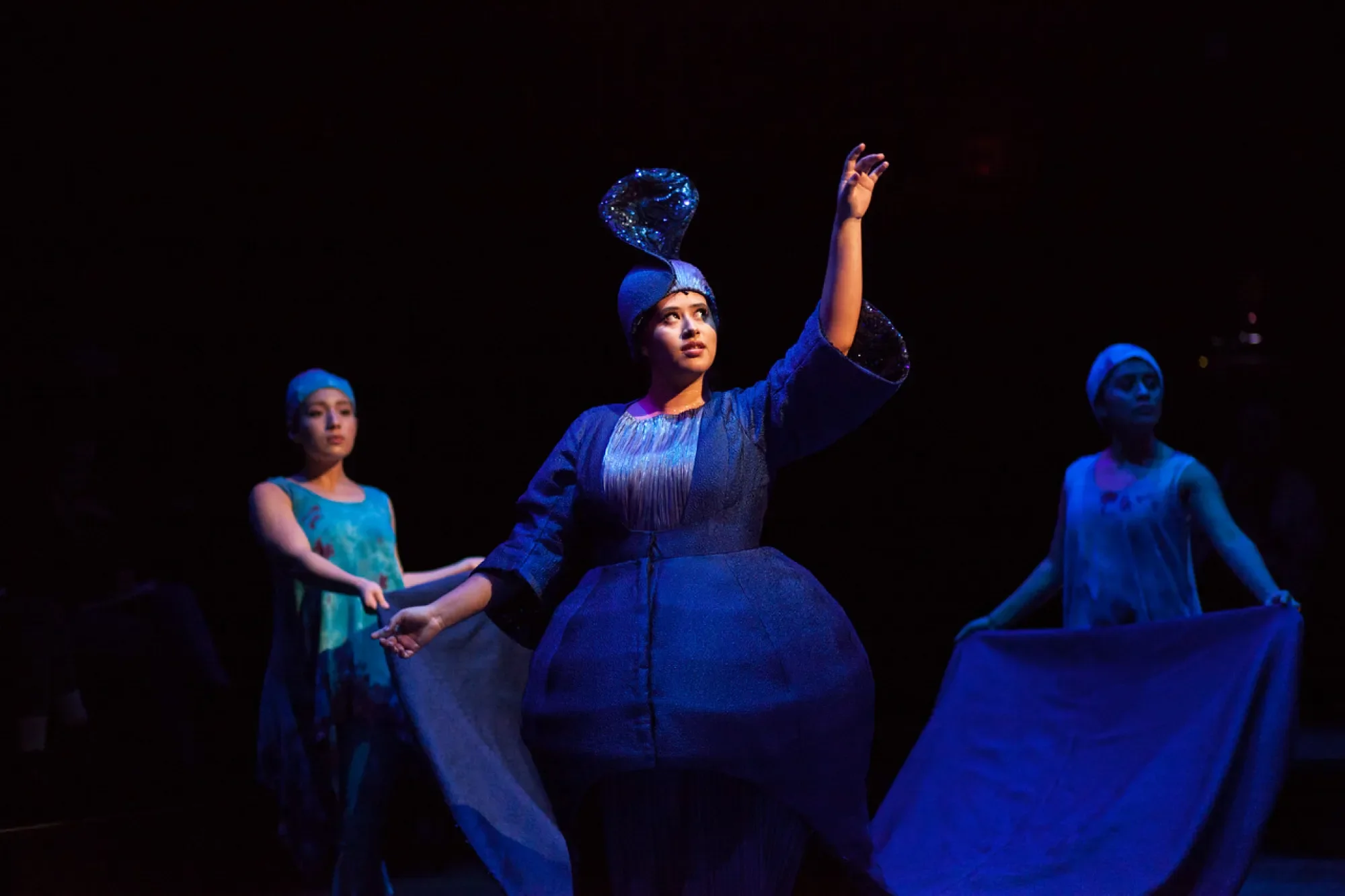 the whale in blue enters among the shark dancers