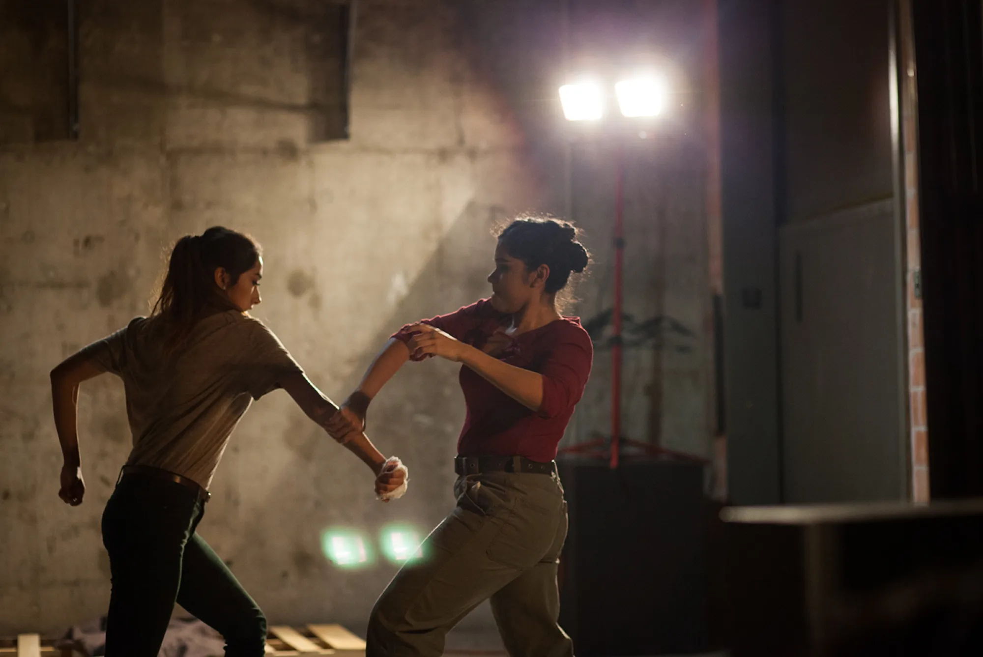 105 (Part 2): Heartweight; Photo: Lawrence Peart two people fight in the dark
