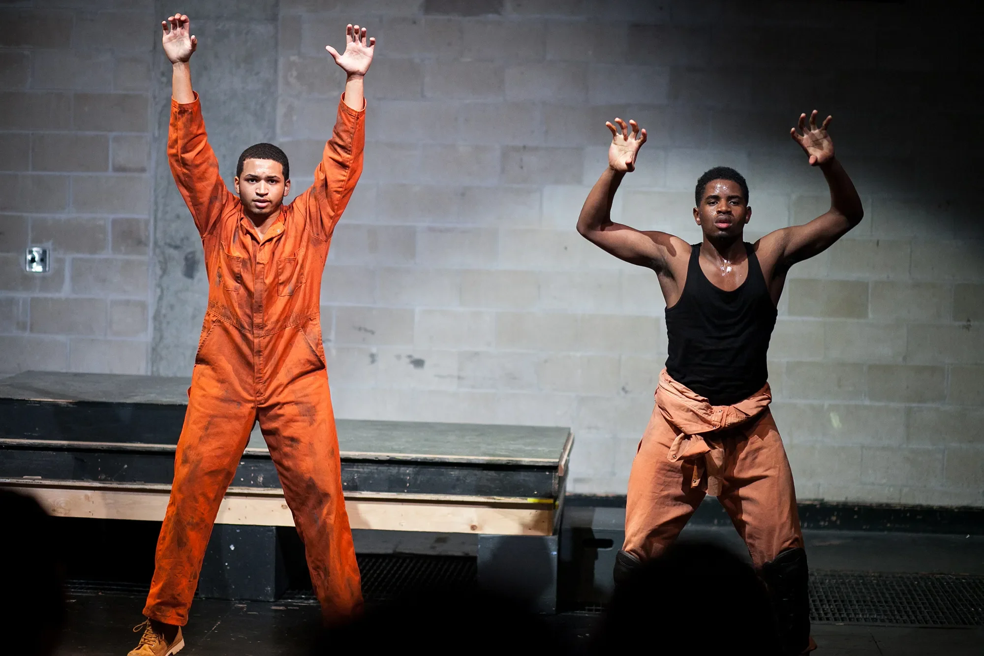 two men holding up arms