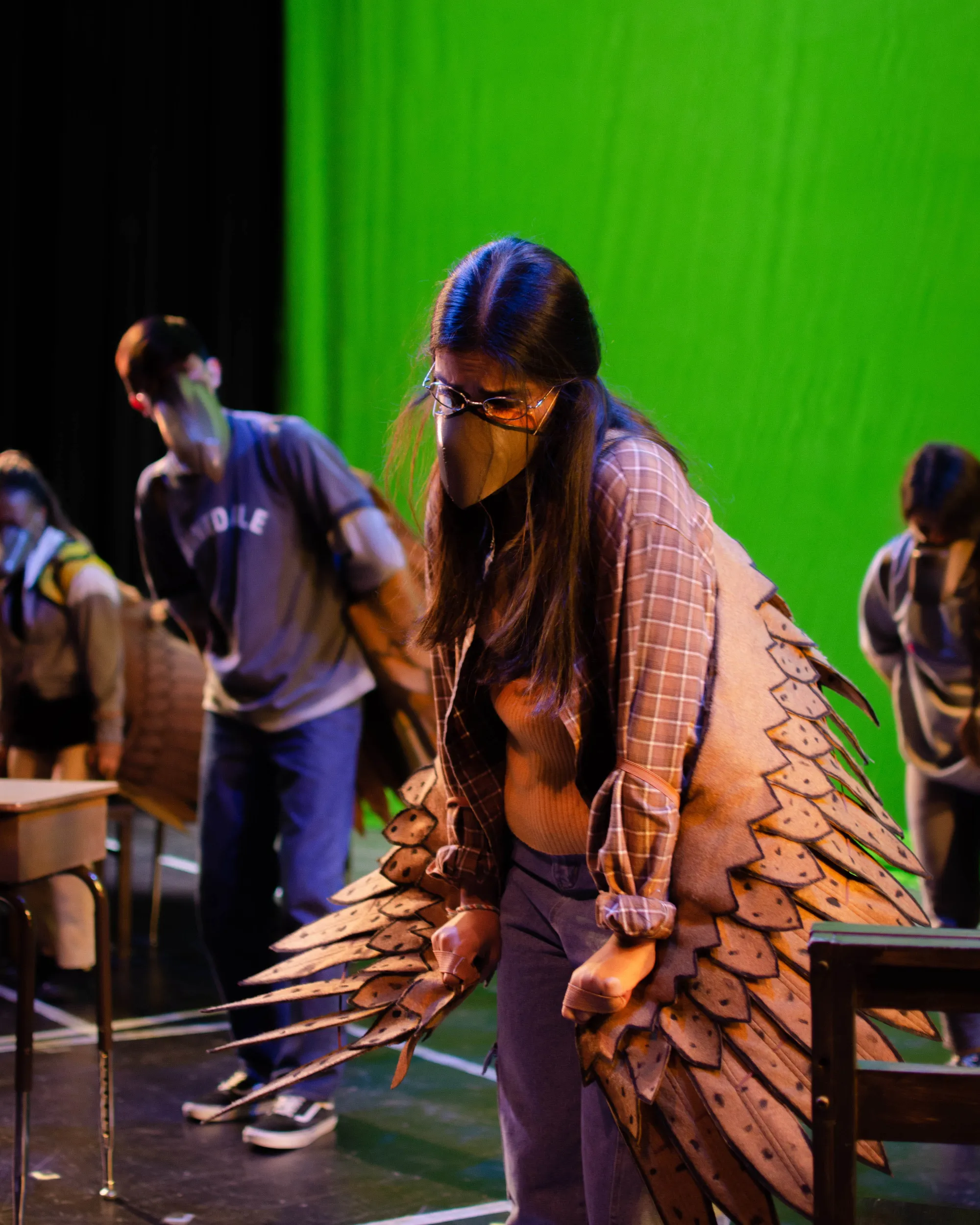 actress wearing detailed brown wings and a beak looks disheartened