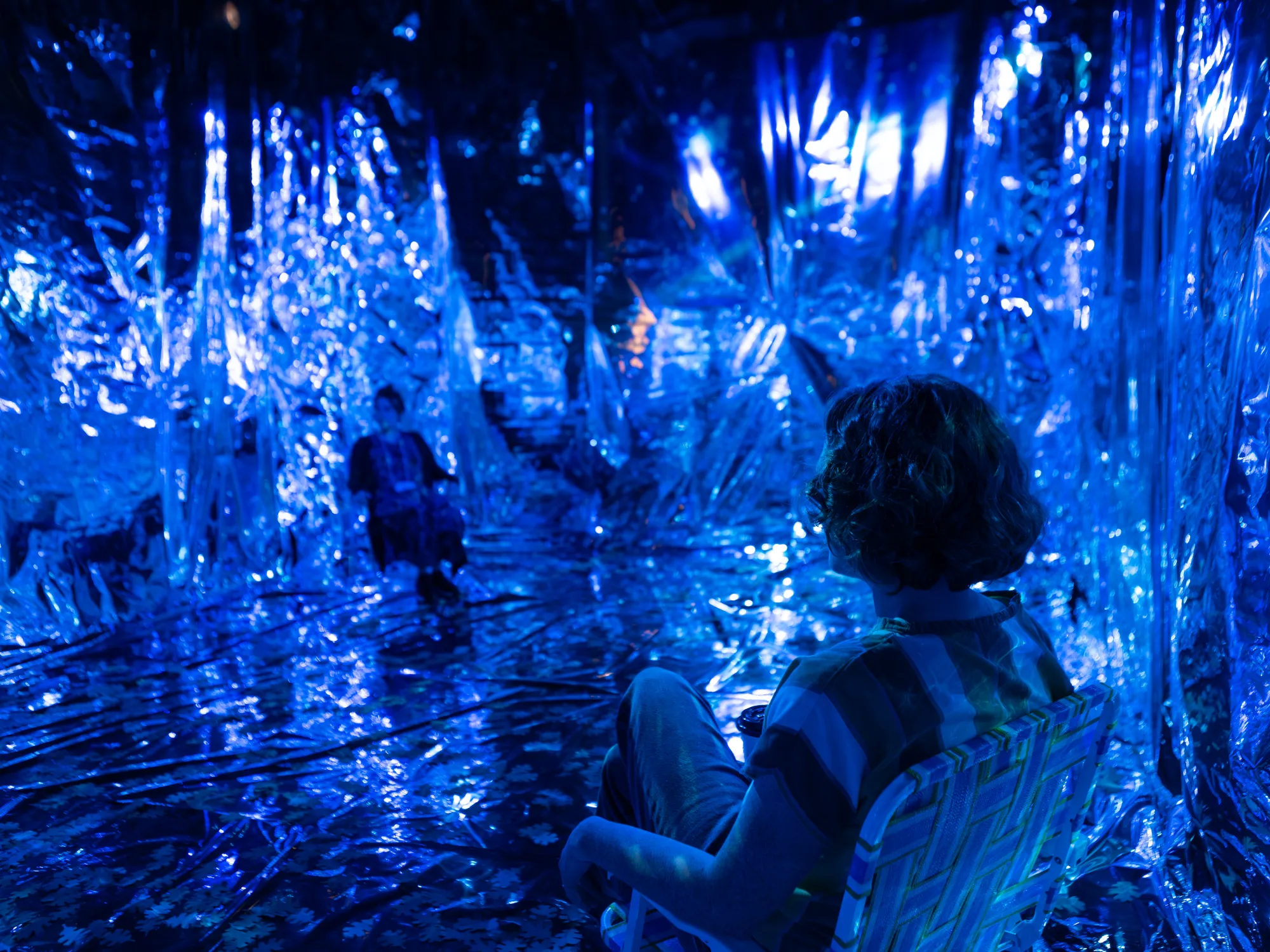 Two audience members sit in an immersive installation presented during The Cohen New Works Festival
