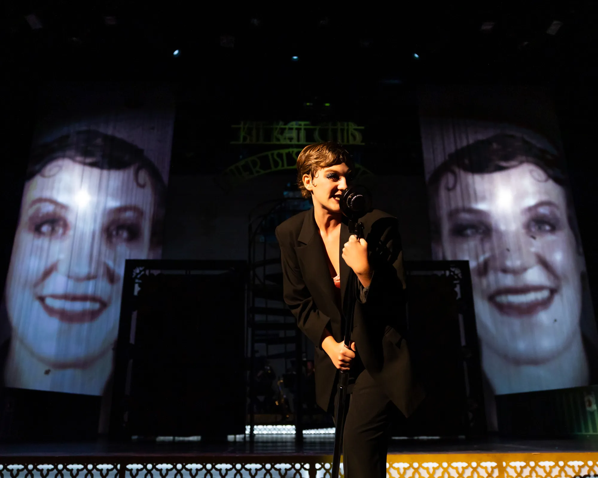 A woman sings into a microphone