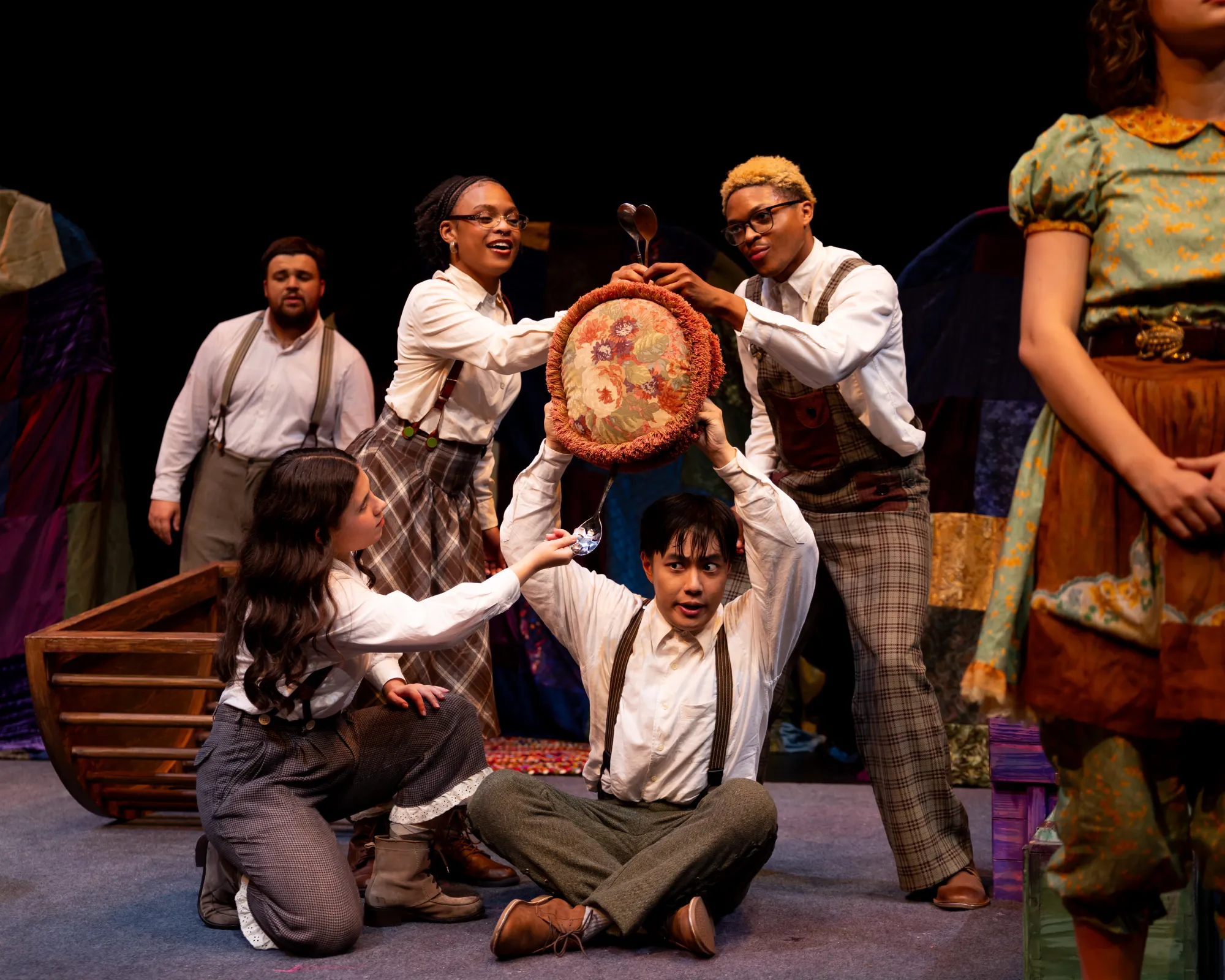 A boy upholds a pillow