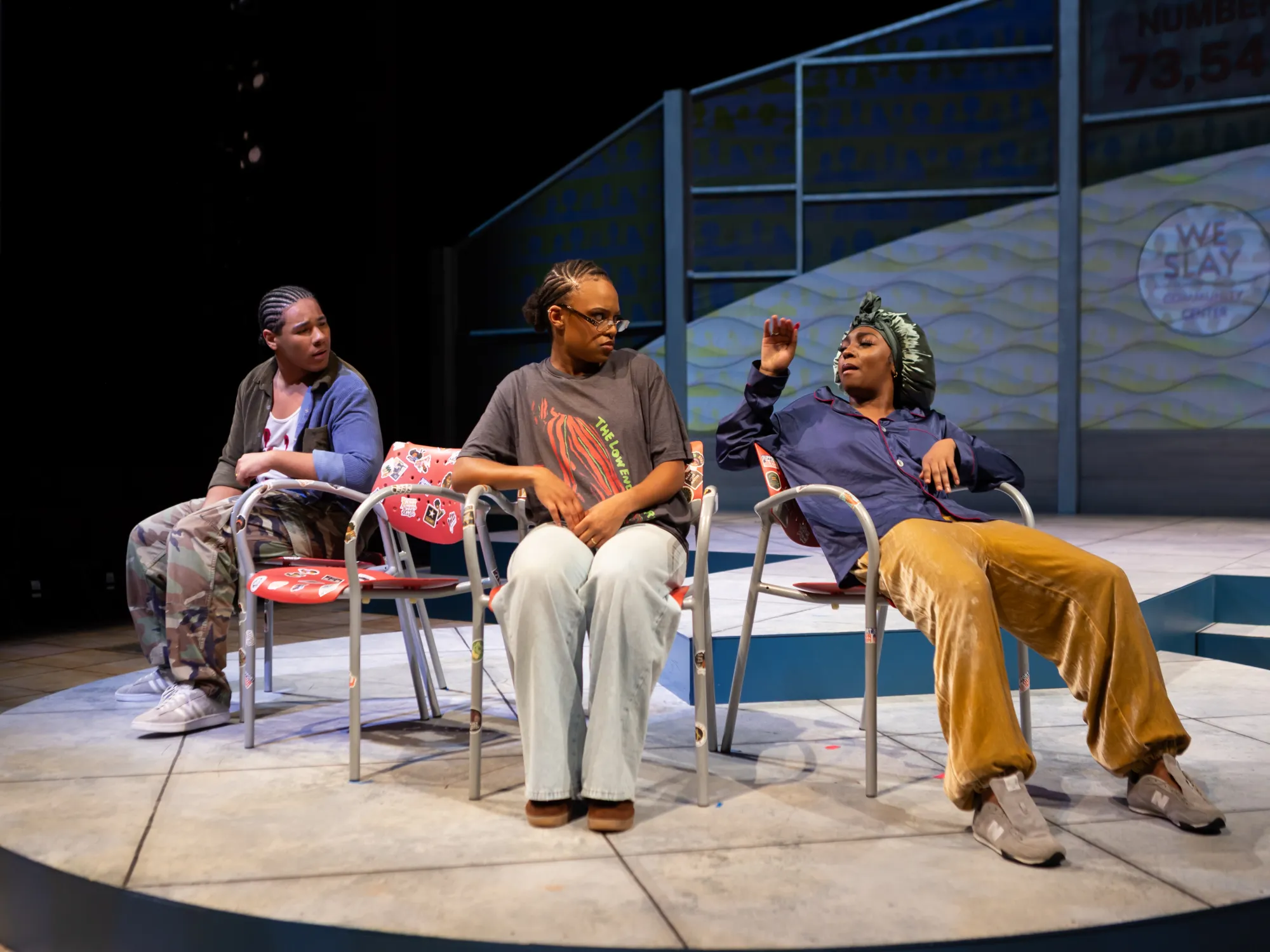 Three actors sitting in waiting room chairs