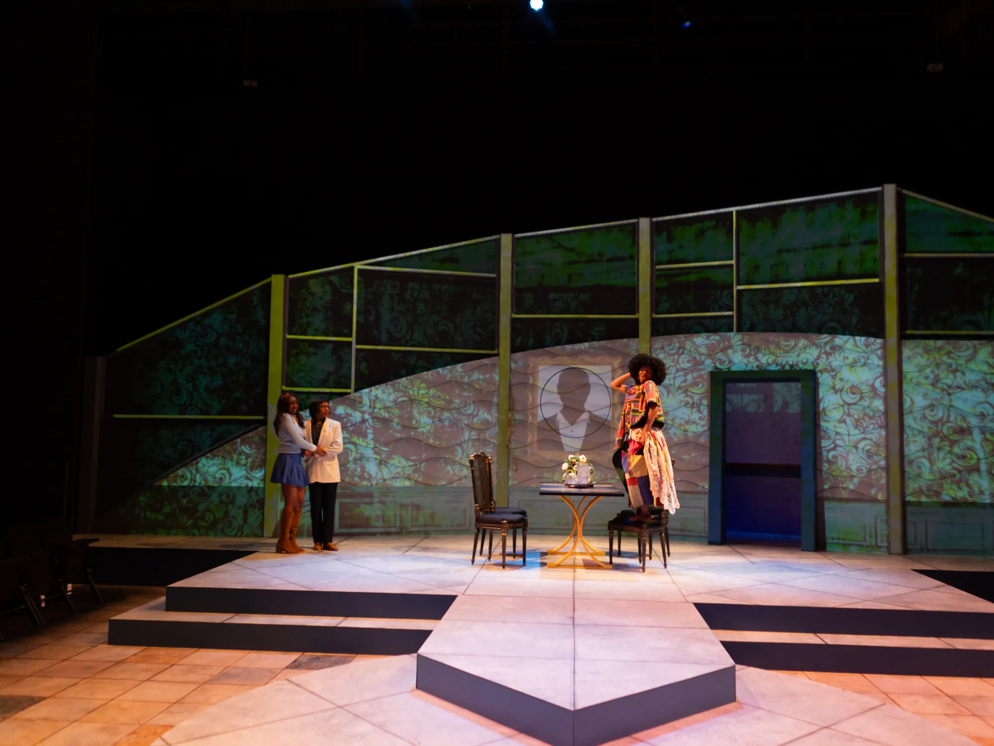 A group of actors stand in fear of an actor with an afro