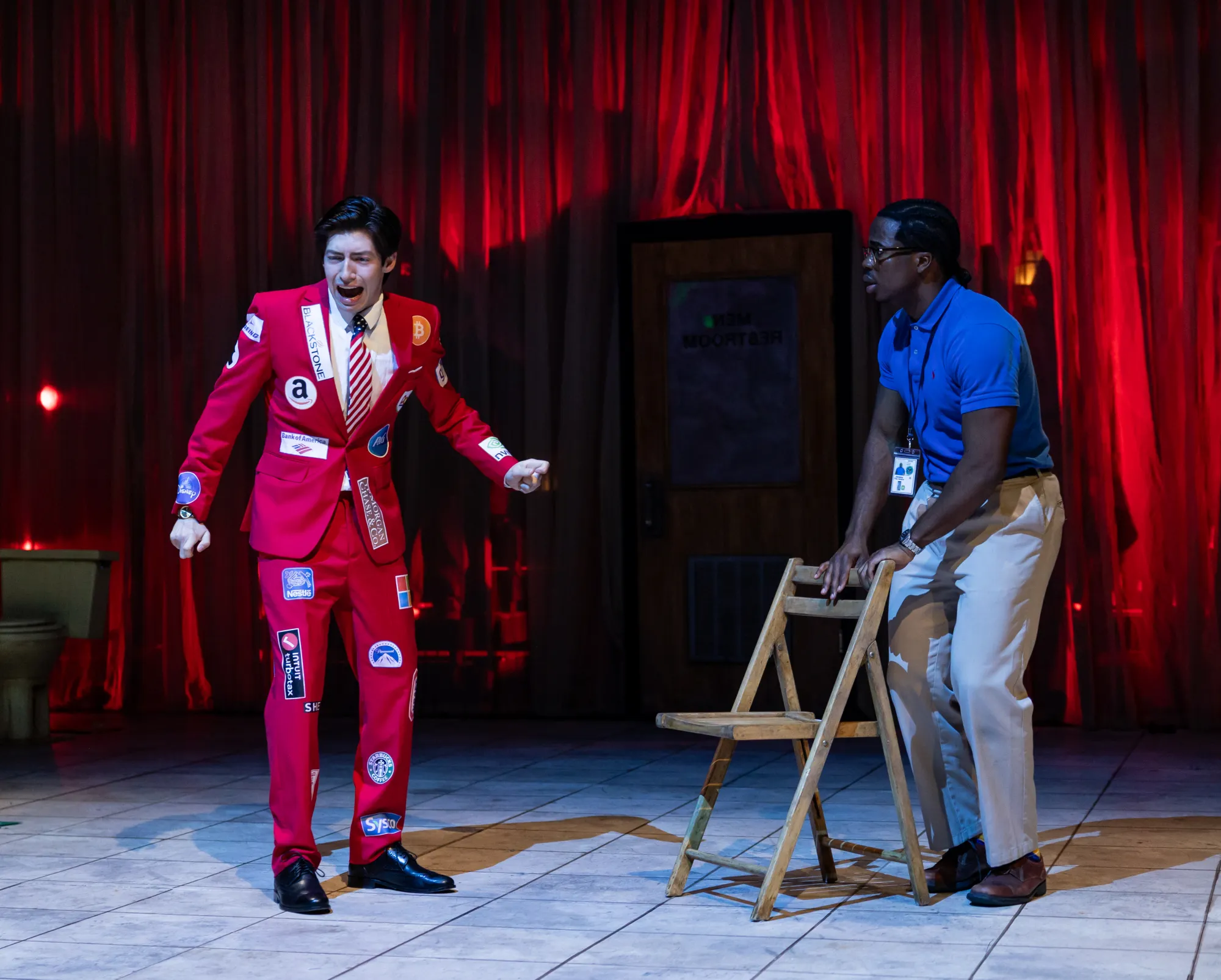 A man in a red suit covered in logos yells