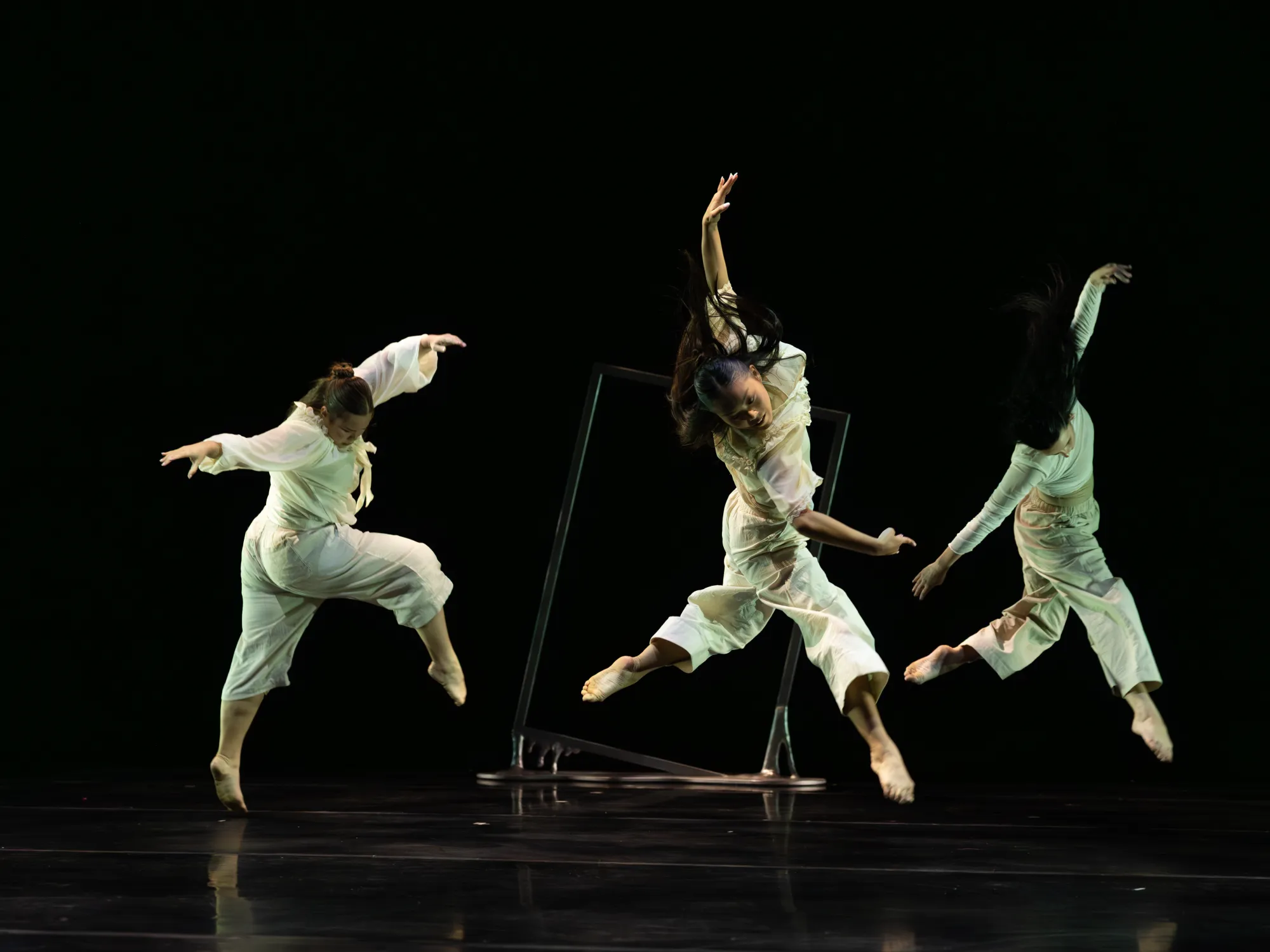 Three dancers jumping