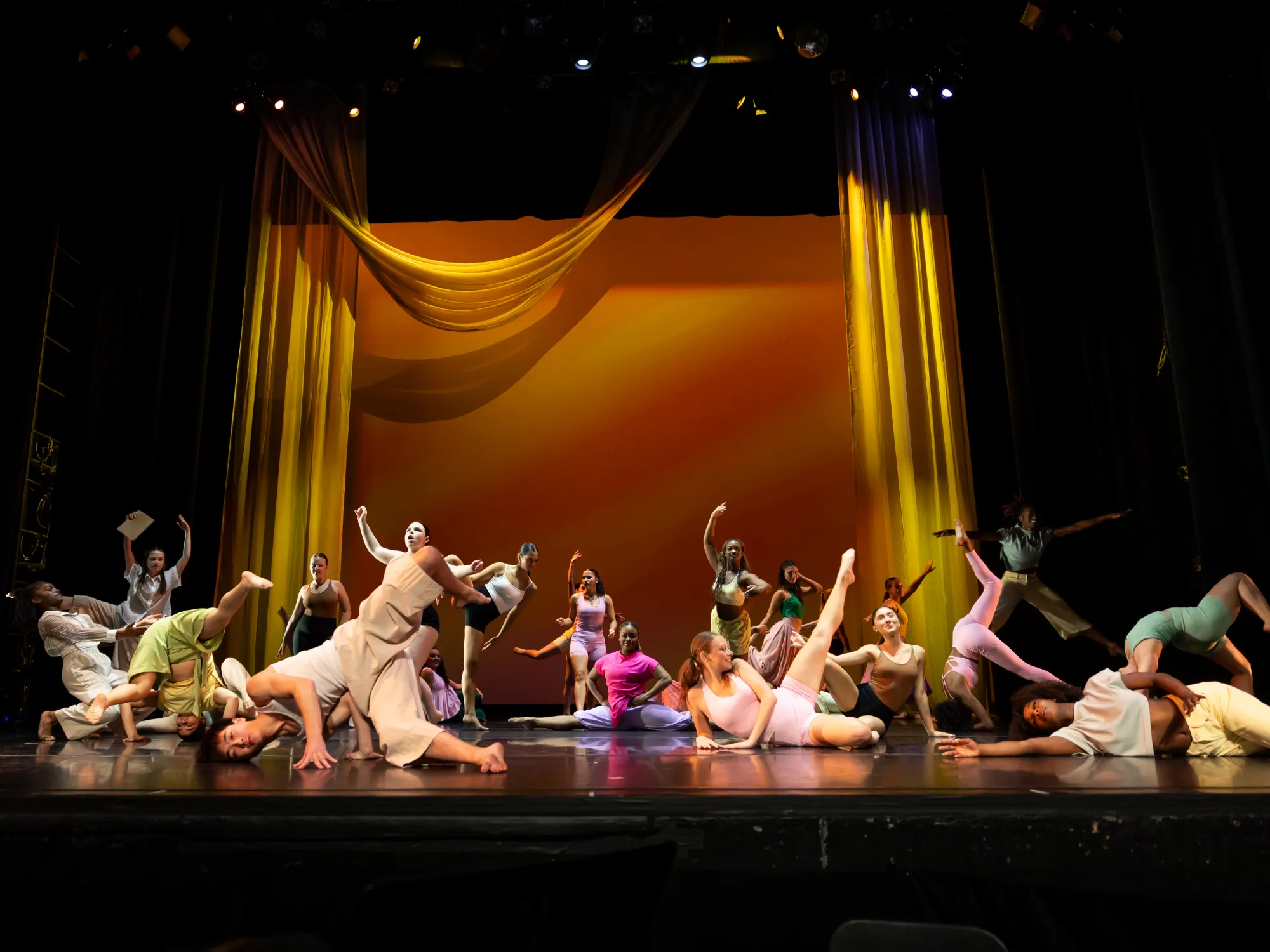 A large group of dancers dressed in colorful attire
