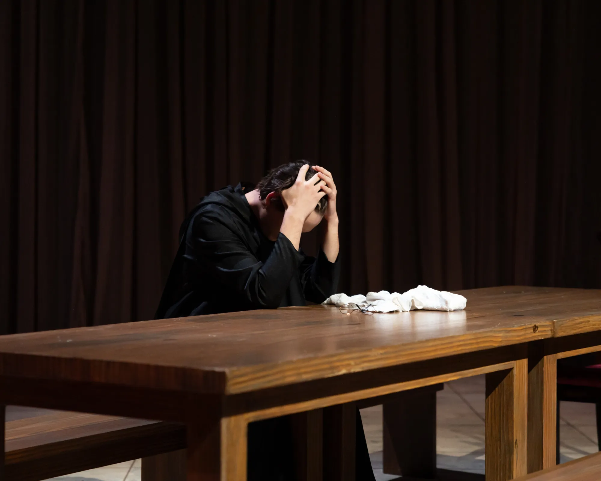 A monk bows his head in grief