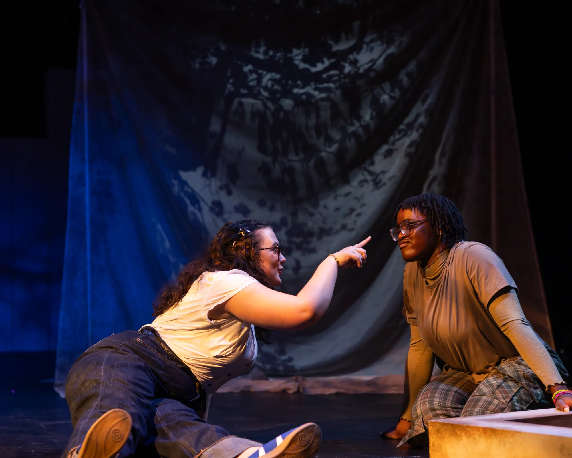 An actor points her finger at another