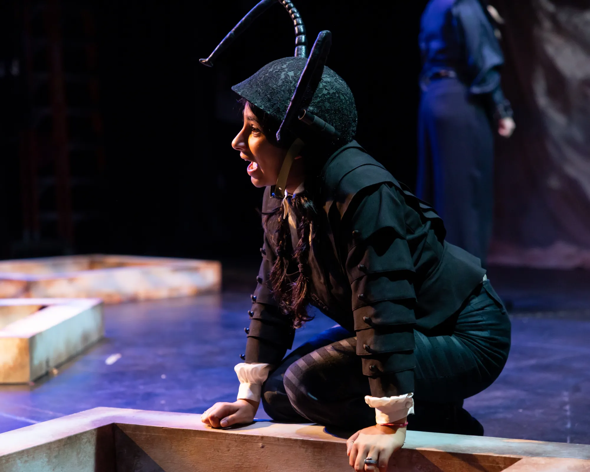 An actor dressed as an ant yells