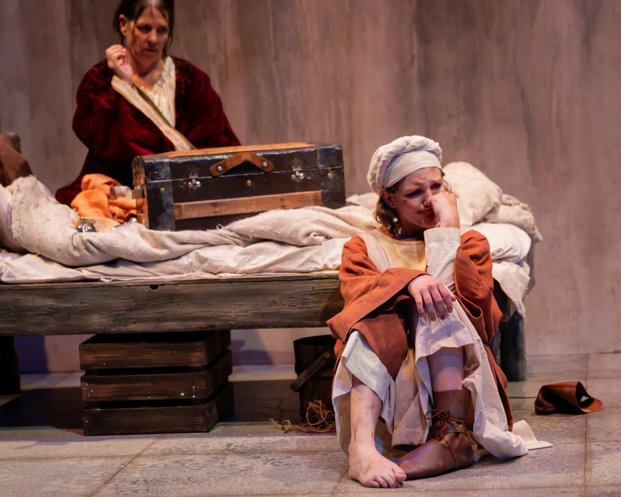 A girl wearing one shoe sulks