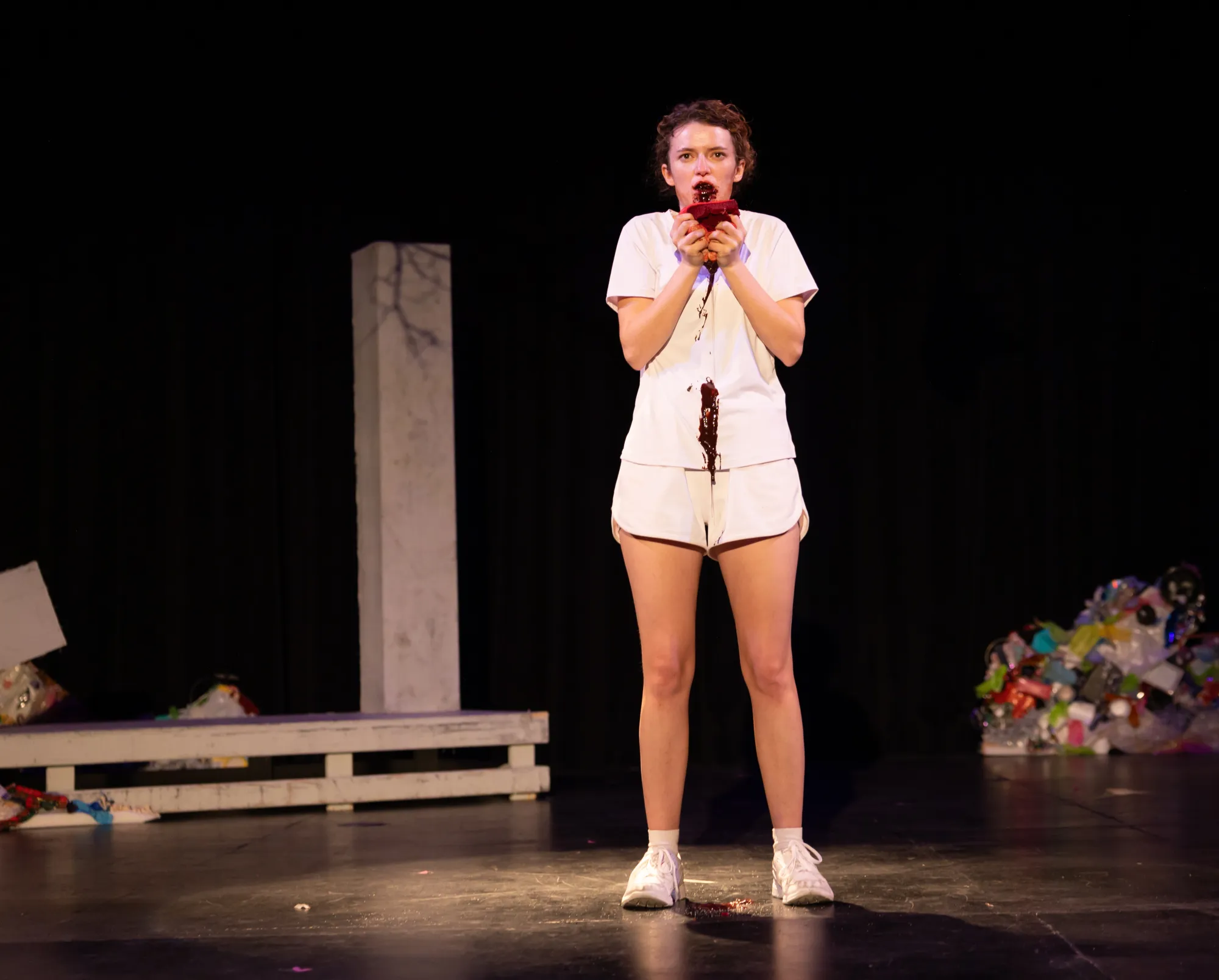 An actor dressed in white eats messily