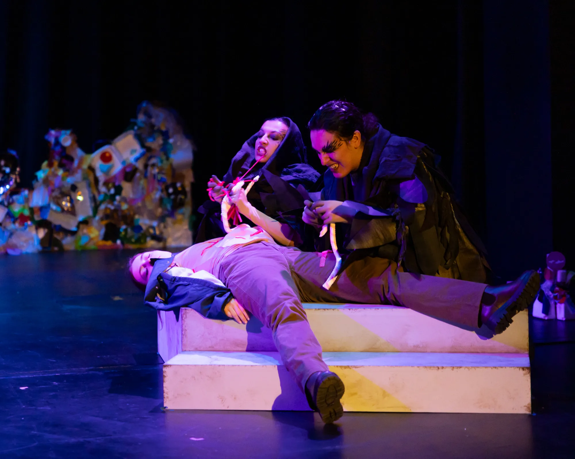 Two actors eat candy designed to simulate innards