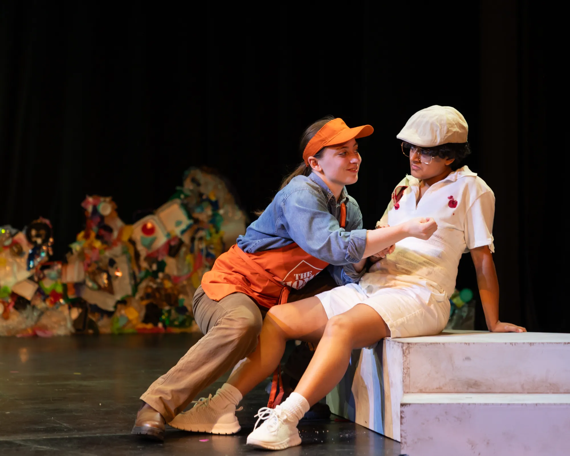 An actor dressed in a Home Depot outfit smiles