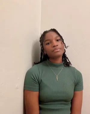 Woman with black braids in a green shirt