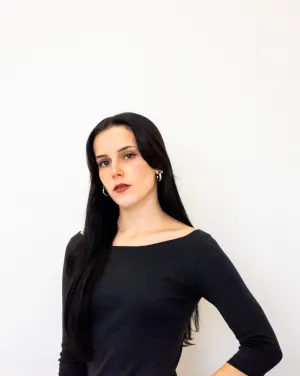 Woman with black hair in a black shirt