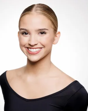 Woman in bun and black shirt smiles