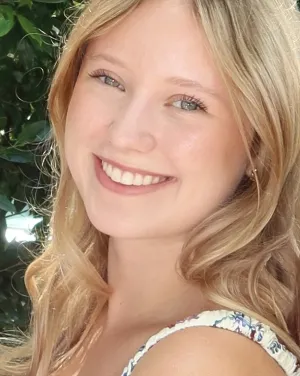 Woman in blue dress smiles