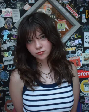 Headshot of Penny Lou Zimmerman in a striped tank top 
