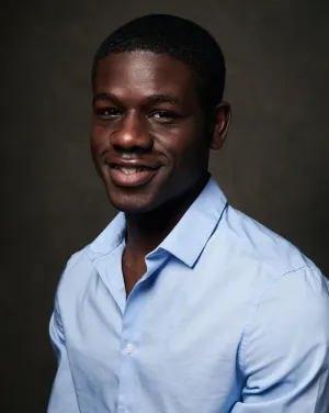 A man in a light blue collared shirt