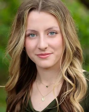 A woman with blonde hair looks forward