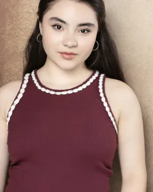 A woman with black hair wearing a red shirt