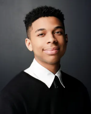 A man in a collared shirt and a tie