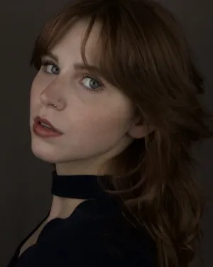 A woman in a black shirt turns her head