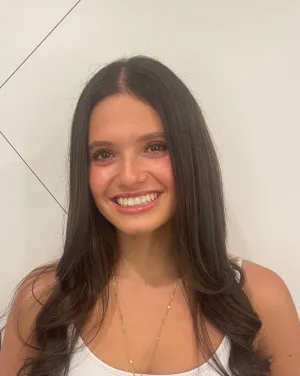 A woman with long black hair smiles