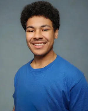 Photo of a man smiling in a blue shirt 
