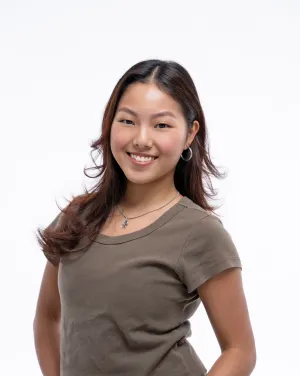 A woman in a brown shirt smiles