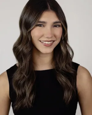 A woman in a black shirt with long brown hair