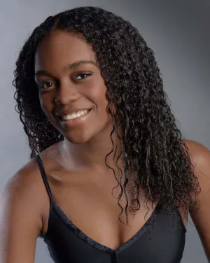 A woman wearing a black shirt smiles