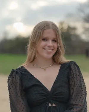 A woman with blonde hair in a black long-sleeved shirt