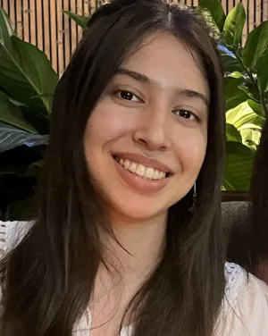 A woman with long brown hair smiles