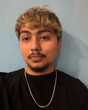 A man in a black shirt wearing a silver chain