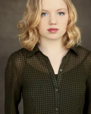 A woman with short blonde hair wearing a button-up blouse