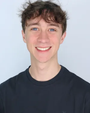 A man in a black t-shirt smiles