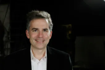 Smiling man in front of black background